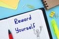 Motivation concept meaning Reward Yourself with inscription on the piece of paper Royalty Free Stock Photo