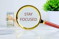 Motivation concept. STAY FOCUSED through a magnifying glass Royalty Free Stock Photo