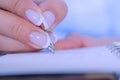 Close up view - woman writing to do list in vintage notebook organizer