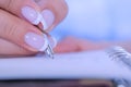 Close up view - woman writing to do list in vintage notebook organizer Royalty Free Stock Photo