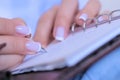 Close up view - woman writing to do list in vintage notebook organizer Royalty Free Stock Photo