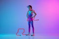 Motivation. Serious sportive girl, junior runner in stylish sportswear and cap posing  on gradient pink-blue Royalty Free Stock Photo