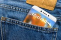 Motivation text concept on the display of a smartphone placed in a jeans pocket. Royalty Free Stock Photo