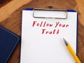 Motivational concept about Follow Your Truth with sign on the sheet