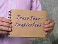 Motivational concept meaning Train Your Imagination with inscription on the piece of paper