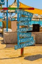 Motivational and freedom lifestyle sign on wooden boards at entrance to beach bar close to the Black Sea on a sunny day