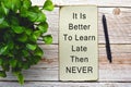 Motivational and inspirational quote on burnt edge paper with green plant Royalty Free Stock Photo