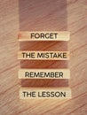 Motivational inspirational quote. Forget the mistake, remember the lesson text on wooden blocks background. Stock photo. Royalty Free Stock Photo