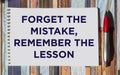 Motivational and inspirational quote - Forget the mistake, remember the lesson, written on a notepad on a striped background Royalty Free Stock Photo