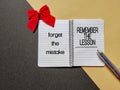 Motivational and inspirational quote of forget the mistake, remember the lesson written on notepad Royalty Free Stock Photo