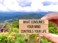 Motivational inspirational quote. What consumes your mind, controls your life on wooden blocks with nature background. Royalty Free Stock Photo