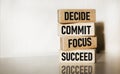 Motivational and inspirational quotes - Decide, commit, focus, succeed on wooden blocks and white background Royalty Free Stock Photo