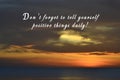 Motivational quote on background of sunset light.