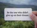 Motivational and inspirational wording. Be the one who didnât give up on their dreams written on a paper. Royalty Free Stock Photo