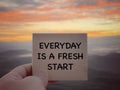 Motivational and inspirational wording. Everyday Is A Fresh Start written on a paper. With blurred styled background.