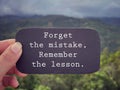 Motivational and inspirational wording. Forget the mistake, remember the lesson written on a paper. Royalty Free Stock Photo