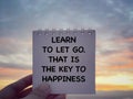 Motivational and inspirational wording. Learn To Let Go. That Is The Key To Happiness written on a notepad. Royalty Free Stock Photo