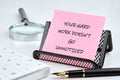 A motivational note reinforces the importance of recognizing effort, placed on a desk with a pen, calculator, and