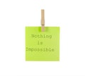 green nothing is impossible motivational sticky note with clothespin isolated on white background Royalty Free Stock Photo