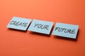 Motivational phrase Create Your Future made of sticky notes with words on orange background Royalty Free Stock Photo