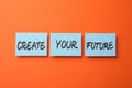 Motivational phrase Create Your Future made of sticky notes with words on orange background Royalty Free Stock Photo