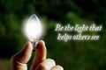 Motivational quote about being the light that helps others see with closeup light bulb background Royalty Free Stock Photo