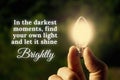 Motivational quote about darkest moments with closeup light bulb background