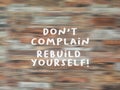 Motivational quote - Do not complain, rebuild yourself. Sign on blurry wooden pattern texture backgrounds. Grateful concept.