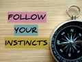 Motivational quote `Follow Your Instincts`.