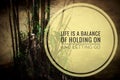 Motivational quote - Life a balance of holding on and letting go. With Bamboo and water background. Royalty Free Stock Photo