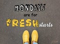 Motivational quote Mondays are for Fresh Starts and closeup view of woman standing on asphalt road Royalty Free Stock Photo