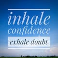 A motivational quote, "INHALE CONFIDENCE EXHALE DOUBT" isolated on blue sky landscape. Royalty Free Stock Photo