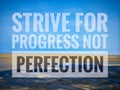 A motivational quote, "STRIVE FOR PROGRESS NOT PERFECTION" isolated on beach background. Success concept. Royalty Free Stock Photo