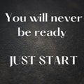 Motivational quote "You will never be ready, just start" on concrete surface background Royalty Free Stock Photo