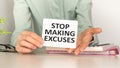 Motivational text Stop making excuses on paper on notebook background