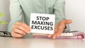 Motivational text Stop making excuses on paper on notebook background Royalty Free Stock Photo