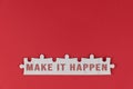 Motivational words - Make it happen. Positive motivation text on white puzzle jigsaw on red background.