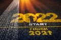 2022 tyre trail. Motivational writing 2022 on asphalt as a metaphor for moving forward and happy new year top slide cover calendar