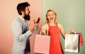 Motives for shopping. couple of shoppers. man shout on woman shopaholic. gift packages for holiday. seasonal discount