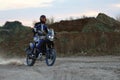 The biker rides a motorcycle in a quarry