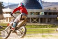 Moto cross biker at race- a sharp turn and the spray of dirt, rear view - close up