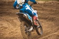 Moto cross - MX girl biker at race in Russia - a sharp turn and the spray of dirt, rear view - close up