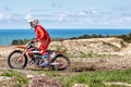 Moto extreme motorcycle rides through the mud against the backdrop of the sea coast Royalty Free Stock Photo