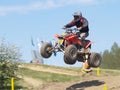 Moto quad jumping from hill Royalty Free Stock Photo