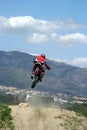 Moto X Motorbike jumping through the air on a hot sunny day with big blue sky Royalty Free Stock Photo