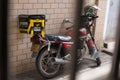 Motobike with Meituan food delivery case parking on the street