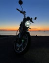 motobike on suset at beach Baltic sea Royalty Free Stock Photo