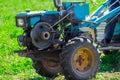 Motoblock plows soil in the farm summer Royalty Free Stock Photo