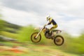 Motocross bike rider jumping in motion Royalty Free Stock Photo