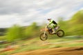 Biker on motocross jump in motion Royalty Free Stock Photo